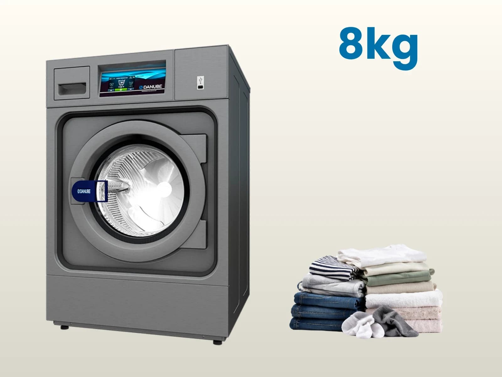 Machine à laver de 8 kg à côté d’une pile de linge du quotidien : jeans, t-shirts, serviettes et chaussettes